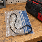 GE WH01X27538 drive belt in its labeled polybag, workbench lifestyle illustration