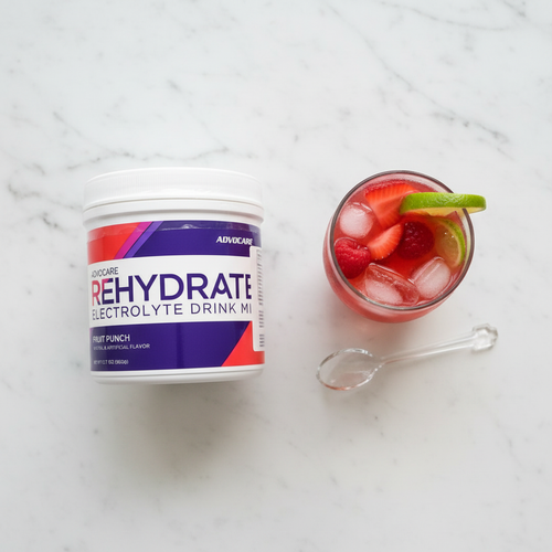 AdvoCare Rehydrate Fruit Punch tub on marble with fruit punch glass and ice – More4less Outlet