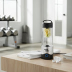 Magic Bullet Portable Blender on wooden coffee table in fitness studio with folded towel and wireless earbuds for gym routine