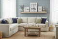 Coastal farmhouse living room staging with distressed white textural leaf-pattern decor frames