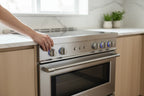 Clean modern kitchen range with burners being adjusted by hand
