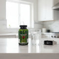 Irwin Naturals Prosta-Strong RED bottle on white quartz breakfast bar with glass of water and fitness tracker