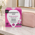 Summer's Eve Simply Sensitive daily gentle cloths box beside a blush travel pouch