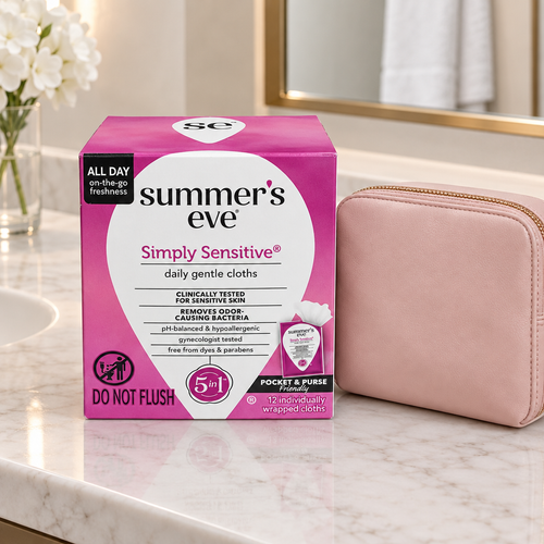 Summer's Eve Simply Sensitive daily gentle cloths box beside a blush travel pouch