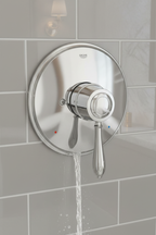 Grohe Fairborn polished chrome shower trim set installed on grey subway tile shower wall with water running traditional elegant bathroom