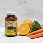 MegaFood Men's 55+ Advanced Multivitamin amber glass bottle beside fresh organic oranges broccoli and carrots on white marble – More4less Outlet