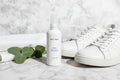 Dr. C. Tuna Foot Spray on marble floor with sneakers and eucalyptus lifestyle