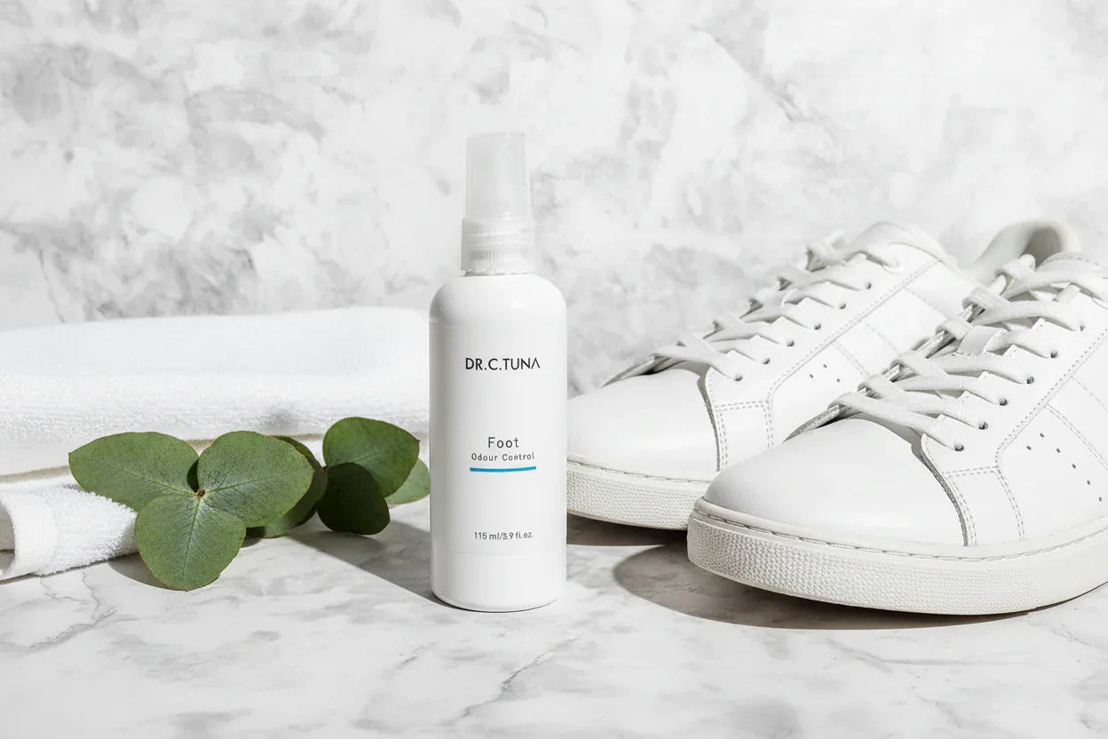 Dr. C. Tuna Foot Spray on marble floor with sneakers and eucalyptus lifestyle