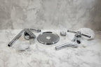 Studio setting displaying chrome shower head and handle trim kit on neutral background
