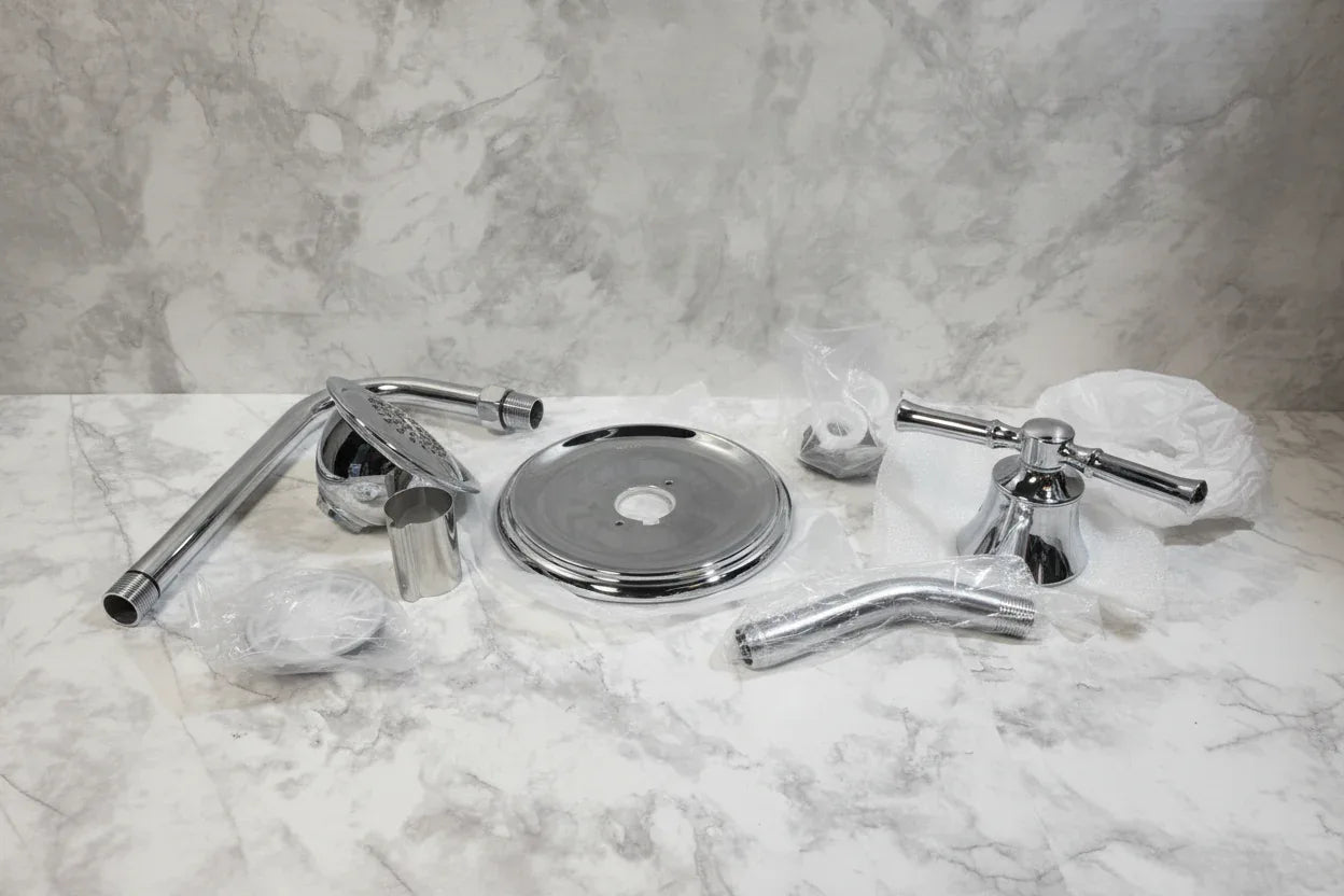 Studio setting displaying chrome shower head and handle trim kit on neutral background