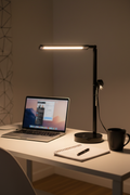 Room and Retreat 16-inch black LED desk lamp illuminated on modern home office desk with laptop notebook and coffee