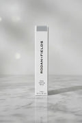 Rodan + Fields Brow Defining Boost Light on professional aesthetic studio background with high key lighting