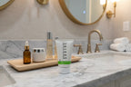 Professional skincare station featuring Rodan + Fields SOOTHE cream wash in high-end home bathroom