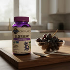 Garden of Life Elderberry Gummies bottle on dark-wood breakfast island with bowl of fresh organic grapes and modern silver spoon