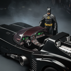 AMT 1989 Batman Batmobile model kit close-up showing assembled cockpit with chrome parts transparent red canopy and resin Batman figure standing beside vehicle