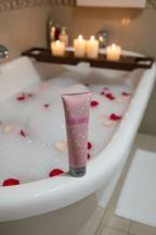Mary Kay Be Delighted Body Wash 4 fl oz on edge of bubble bath with candles and rose petals – More4less Outlet