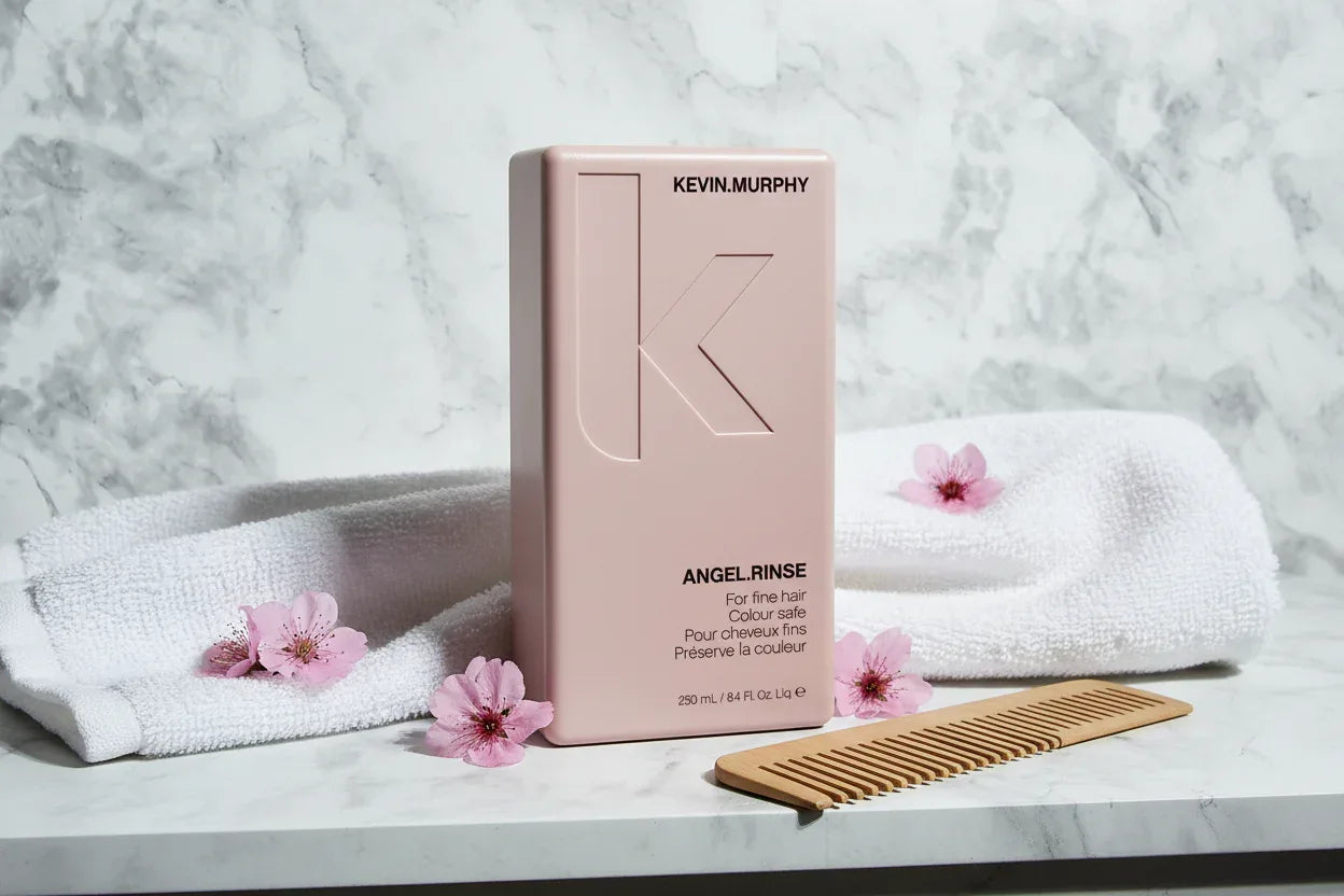 KEVIN.MURPHY ANGEL.RINSE on marble bathroom shelf with comb and towel lifestyle