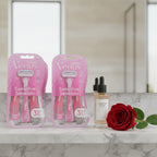 Gillette Venus Sensitive Disposable Razors 6ct on marble bathroom shelf with rose and skin elixir