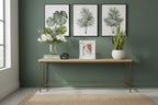 Modern botanical interior design vignette with distressed white leaf-textured portrait frame on console table