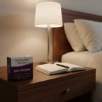 Australian Dream Back Pain Cream 4 oz on dark walnut nightstand with bedside lamp and open journal