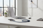 Belkin BoostCharge Pro Flex blue Lightning cable connecting iPhone to laptop USB-A port on modern desk workspace — More4less Outlet