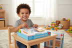 Child drawing on Fisher-Price Learn and Doodle Desk LCD screen with stylus in bright playroom - More4less Outlet