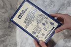 In-hand close-up of Duke Cannon Whisker Wonderland navy blue themed retail gift box with winter scene illustration
