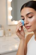 Woman applying loose setting powder with Olivia Rose blue mini powder puff under eye — More4less Outlet