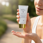 Woman applying JAFRA Royal Revitalize SPF 50 Solar Fluid outdoors in natural sunlight – More4less Outlet