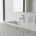 Grohe Concetto chrome bathroom faucet installed on a white marble vanity countertop in a modern bathroom.