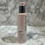 Close up shot of Mary Kay body gel cream showcasing modern pump bottle packaging on natural stone surface