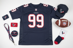 J.J. Watt Houston Texans #99 youth jersey flat lay with football and Texans fan gear – More4less Outlet