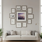 Gallery wall arrangement featuring weathered grey wood square picture frames in a modern living space