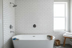 Modern high-end bathroom renovation scene showcasing chrome plumbing volume control trim