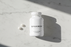 Top-down view of supplement bottle showing intact tamper-evident seal