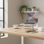 Modern home office desk with smartphone charging via white USB-C cable and compact wall charger