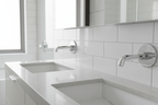 Grohe Lineare New StarLight chrome wall-mount faucet trim on white subway tile in contemporary master bathroom double vanity with morning light