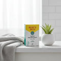 Burt's Bees Herbal Blemish Patch box on white quartz bathroom vanity with cotton face towel and potted succulent