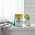 Burt's Bees Herbal Blemish Patch box on white quartz bathroom vanity with cotton face towel and potted succulent
