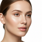 Close-up of a woman's face with visibly firm, radiant, and youthful-looking skin in soft studio lighting