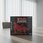 Risk Office Politics adult board game box on a neutral office conference table