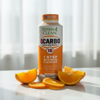 Herbal Clean QCarbo 16 orange bottle on white marble with soft morning light and fresh orange citrus slices – More4less Outlet