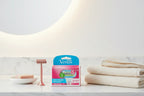 Minimalist personal care vanity with premium razor refill box and soft towels on white marble