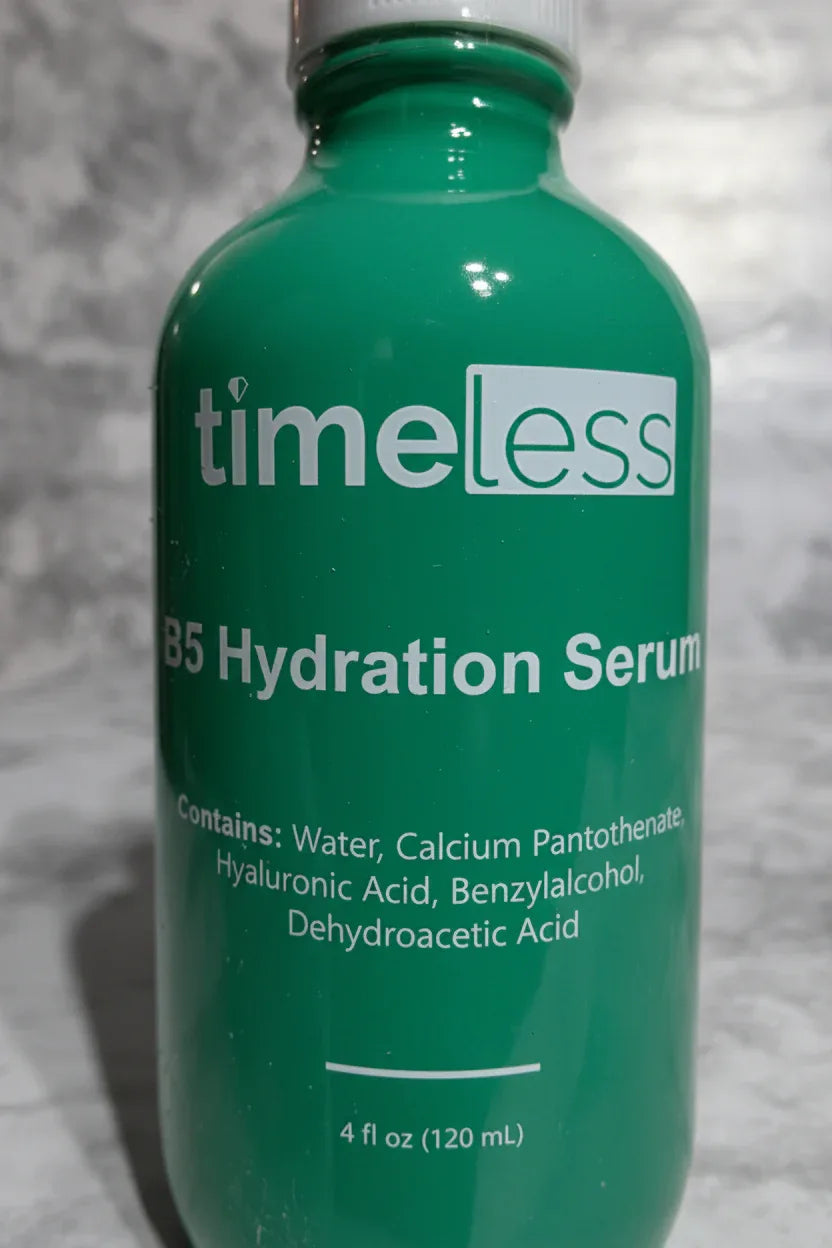 High-quality macro photo focusing on clean white label text on a dark green glass professional beauty serum bottle