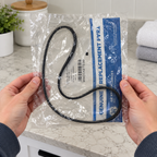 GE WH01X27538 drive belt in its labeled polybag, holding package lifestyle illustration