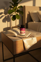 NeoCell Marine Collagen on designer nightstand in sun-drenched contemporary bedroom next to open silk journal