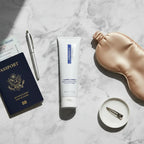 ZO Foamacleanse gentle foaming face wash on marble flat-lay with passport and silk sleep mask travel aesthetic