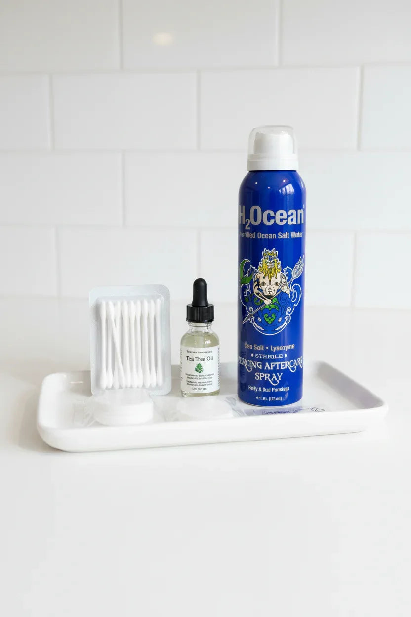 Sterile personal care staples including a blue spray can arranged cleanly on a white medical tray
