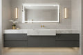 Luxury contemporary bathroom vanity with brushed gold lever hardware on white marble sink