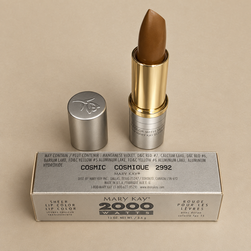 Mary Kay Cosmic 2992 warm bronze lipstick with silver box and rose cap on champagne background